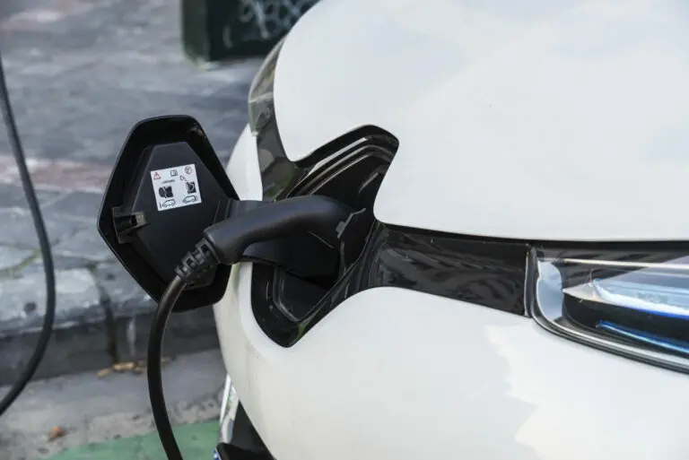 Electric cars being recharged in front of a European car plant, illustrating the European Union's CO2 targets.