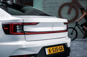 Electric vehicle driving in a city street, global EV adoption
