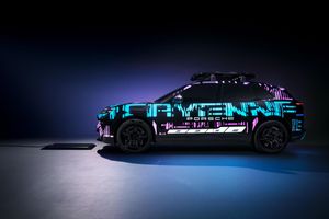 Porsche Cayenne electric 2026 seen in profile, camouflaged prototype at the Munich Motor Show with innovative induction charging