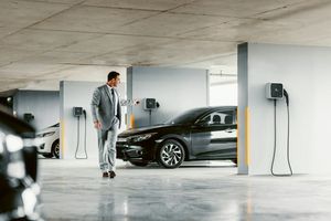 Man leaving his electric vehicle connected to a home charging point