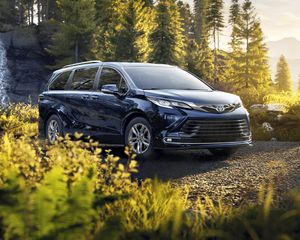 Exterior view of the Toyota Sienna parked on a logging road.