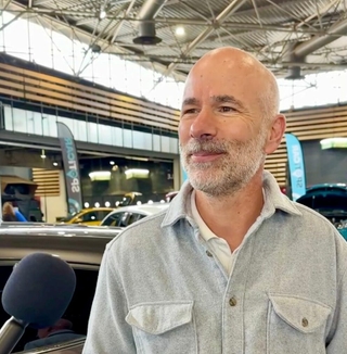 Man interviewed at the Lyon Motor Show about electric vehicles