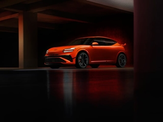 Genesis GV60 Magma front and side view, orange high performance electric SUV