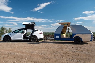 Electric car with parked trailer