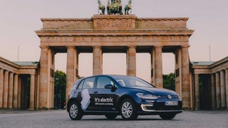 Electric Volkswagen parked in front of the Brandenburg Gate in Berlin